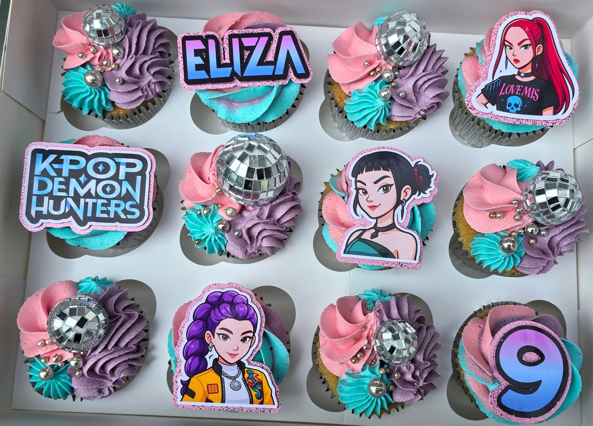Colourful K-pop cupcakes with character toppers and birthday details.